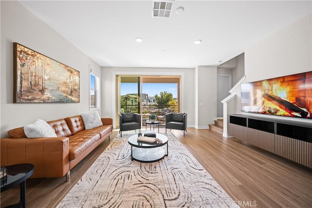 248 Keeper, Irvine, CA 92618 - living area featuring stairs, visible vents, baseboards, and wood finished floors