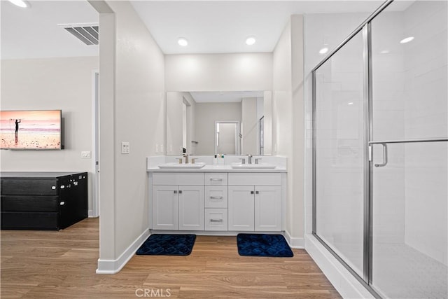 248 Keeper, Irvine, CA 92618 - bathroom featuring visible vents, wood finished floors, a sink, a stall shower, and double vanity