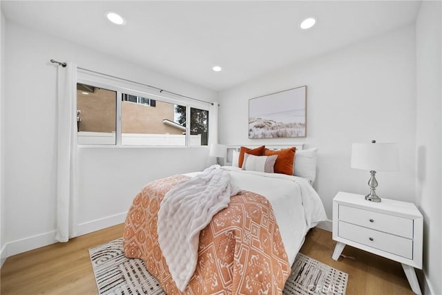 bedroom featuring recessed lighting, baseboards, and wood finished floors