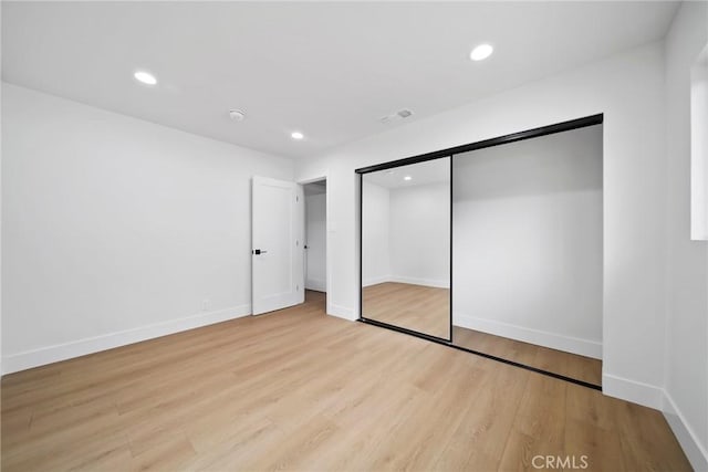 unfurnished bedroom with recessed lighting, baseboards, visible vents, and wood finished floors