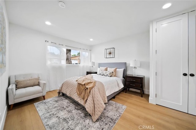 bedroom with recessed lighting, baseboards, and light wood-style floors