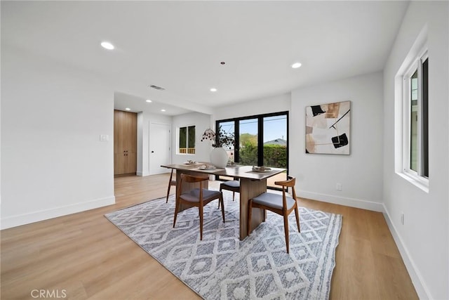 dining space with recessed lighting, baseboards, light wood finished floors, and visible vents