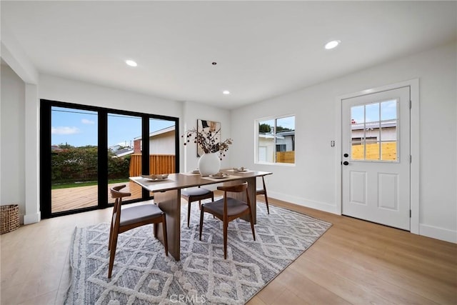 dining room with recessed lighting, baseboards, and light wood-type flooring