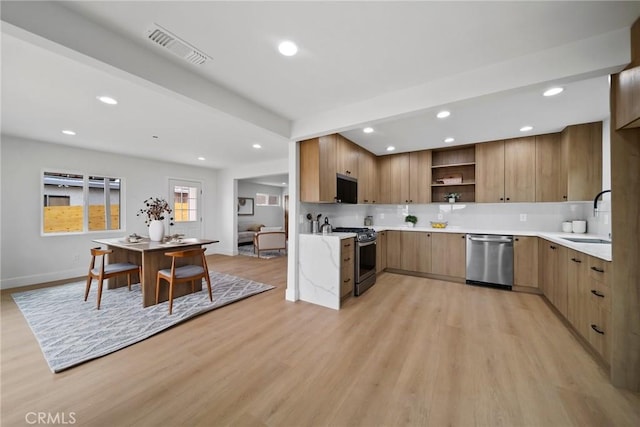 kitchen with visible vents, open shelves, modern cabinets, a sink, and stainless steel appliances