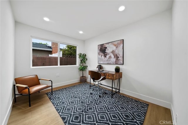 home office featuring baseboards, recessed lighting, and wood finished floors