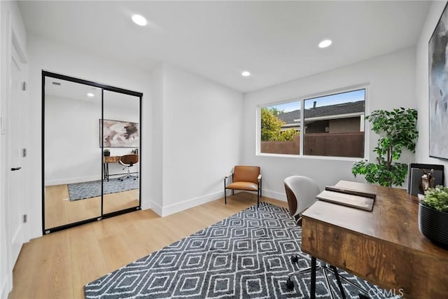 office space with recessed lighting, baseboards, and light wood finished floors