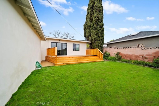 view of yard with fence and a wooden deck