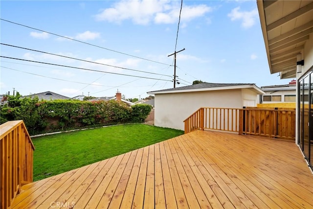 wooden deck with a lawn and fence