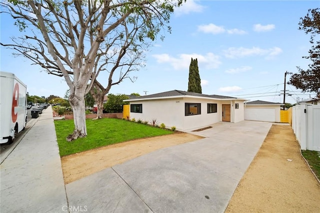 view of front facade featuring roof with shingles, a front yard, a garage, fence, and stucco siding