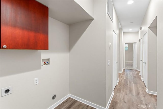 laundry area with laundry area, hookup for a washing machine, electric dryer hookup, wood finished floors, and baseboards