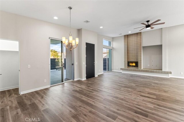 unfurnished living room with a wealth of natural light, recessed lighting, and a tiled fireplace