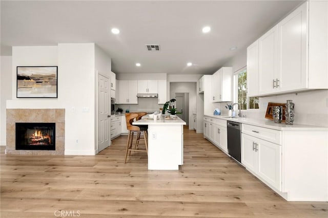 12949 Colonial Dr, Rancho Cucamonga, CA 91739 - kitchen featuring a kitchen breakfast bar, visible vents, recessed lighting, black dishwasher, and under cabinet range hood