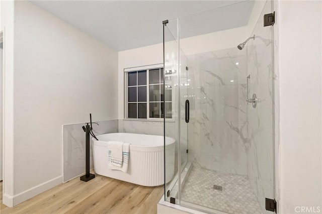 12949 Colonial Dr, Rancho Cucamonga, CA 91739 - full bath with a soaking tub, wood finished floors, a marble finish shower, and baseboards