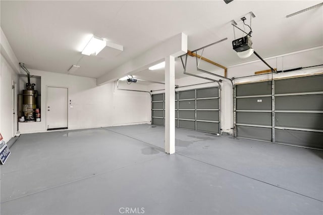 12949 Colonial Dr, Rancho Cucamonga, CA 91739 - garage featuring strapped water heater and a garage door opener