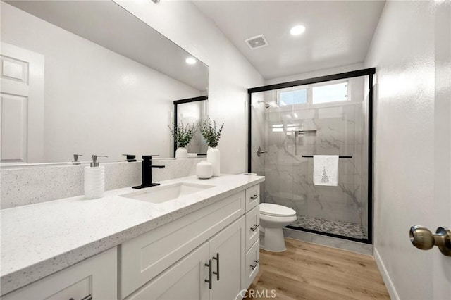 12949 Colonial Dr, Rancho Cucamonga, CA 91739 - full bathroom with visible vents, toilet, vanity, wood finished floors, and a marble finish shower