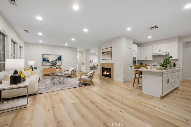 12949 Colonial Dr, Rancho Cucamonga, CA 91739 - living area with light wood finished floors, a fireplace, and visible vents