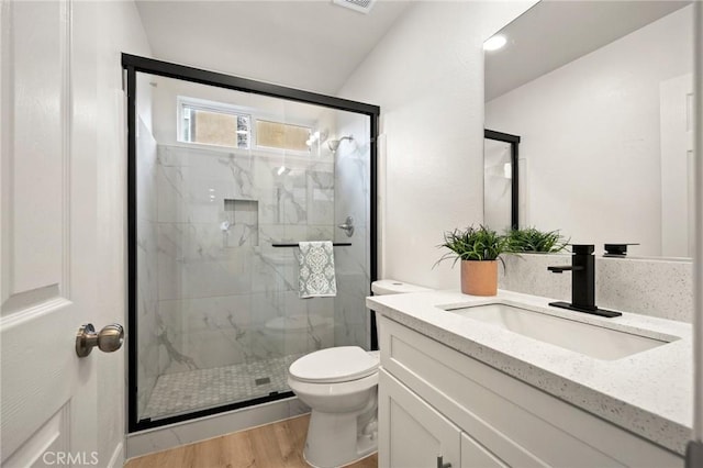 12949 Colonial Dr, Rancho Cucamonga, CA 91739 - full bath featuring toilet, vanity, a marble finish shower, and wood finished floors