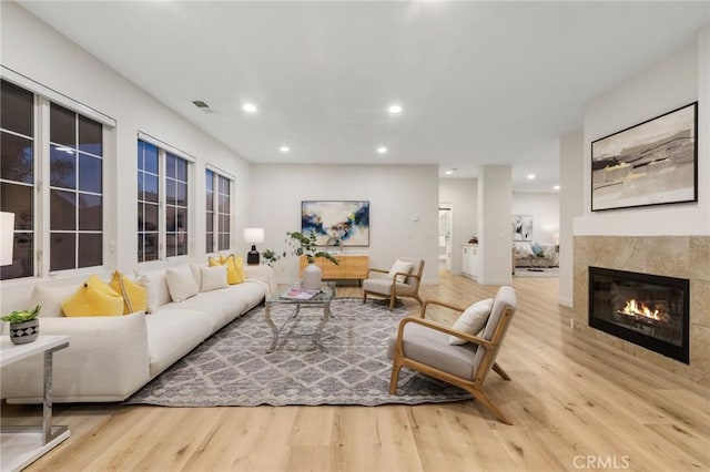 12949 Colonial Dr, Rancho Cucamonga, CA 91739 - living area with wood finished floors, a tiled fireplace, visible vents, and recessed lighting
