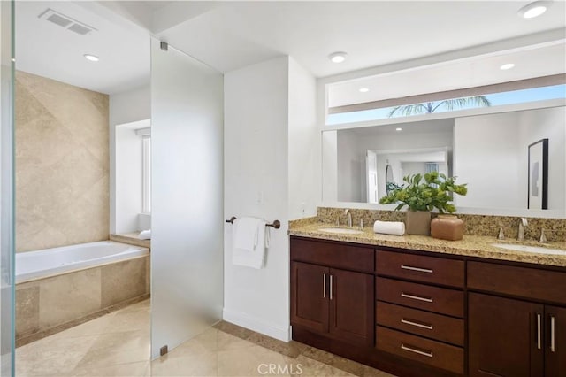 66 Drakes Bay Dr, Corona Del Mar, CA 92625 - bathroom with double vanity, a garden tub, tile patterned flooring, baseboards, and recessed lighting