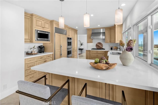 66 Drakes Bay Dr, Corona Del Mar, CA 92625 - kitchen with wall chimney range hood, built in appliances, light countertops, a peninsula, and recessed lighting