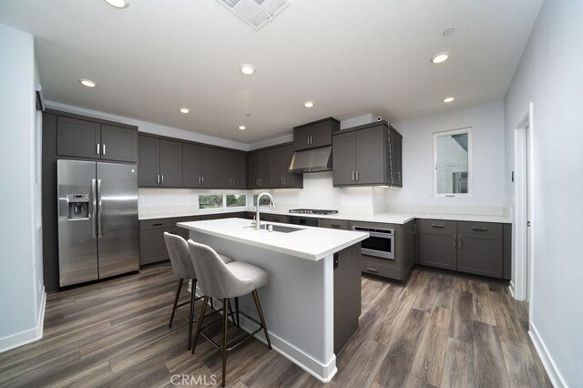 430 Transport, Tustin, CA 92782 - kitchen featuring stainless steel appliances, under cabinet range hood, a sink, dark wood finished floors, and recessed lighting