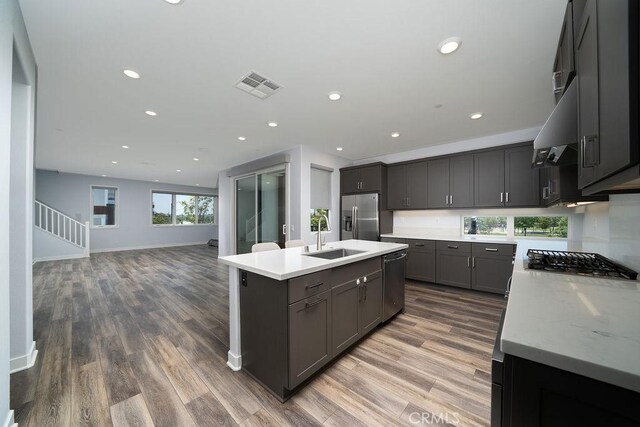 430 Transport, Tustin, CA 92782 - kitchen featuring a sink, stainless steel appliances, light countertops, wood finished floors, and recessed lighting