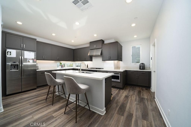430 Transport, Tustin, CA 92782 - kitchen featuring stainless steel fridge, a sink, under cabinet range hood, dark wood finished floors, and a center island with sink