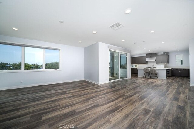 430 Transport, Tustin, CA 92782 - unfurnished living room with dark wood-type flooring, baseboards, and recessed lighting