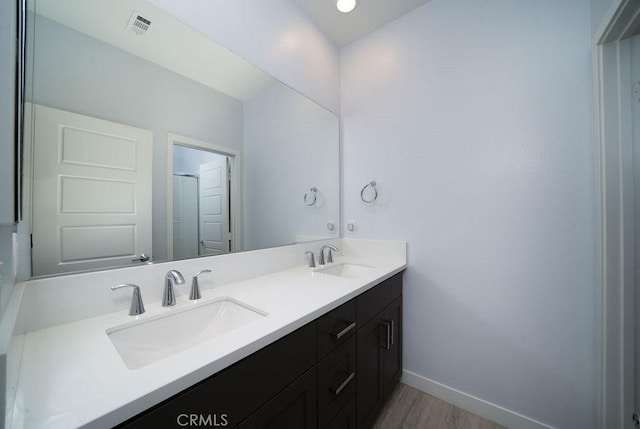 430 Transport, Tustin, CA 92782 - bathroom featuring double vanity, wood finished floors, and baseboards