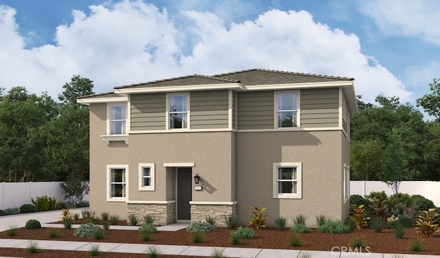 view of front of home with stucco siding, stone siding, and fence