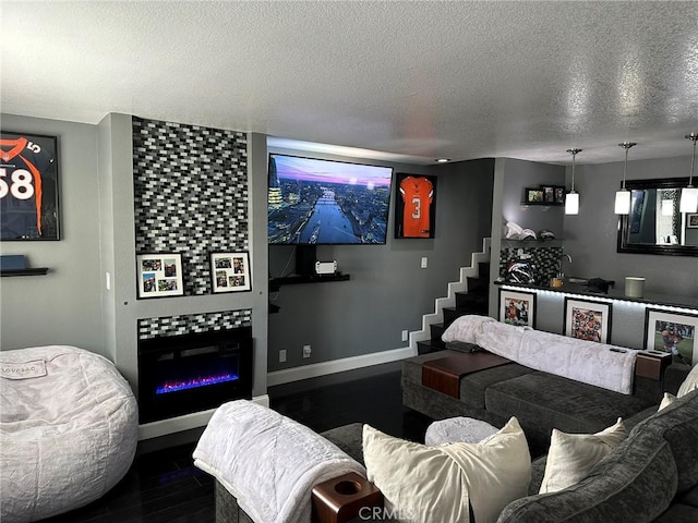 living area featuring a fireplace, dark wood-style floors, a textured ceiling, and baseboards
