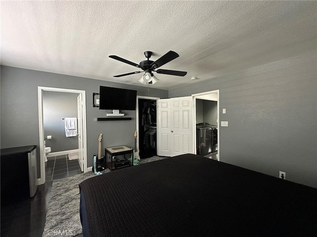 bedroom with a closet, ensuite bath, a textured ceiling, and ceiling fan