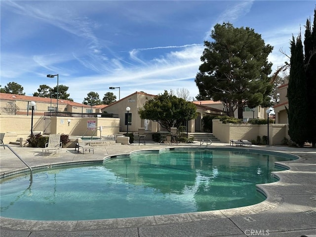 pool featuring a patio and fence
