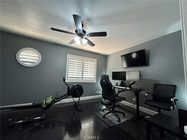 office with ceiling fan, wood finished floors, baseboards, and a textured ceiling