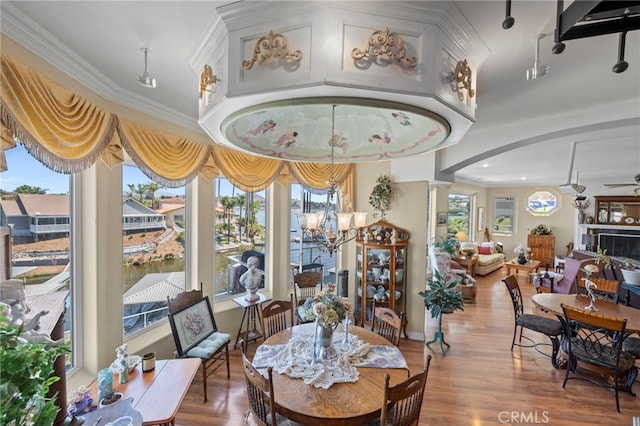 30594 Longhorn Dr, Canyon Lake, CA 92587 - dining space with wood finished floors, arched walkways, a chandelier, crown molding, and a ceiling fan