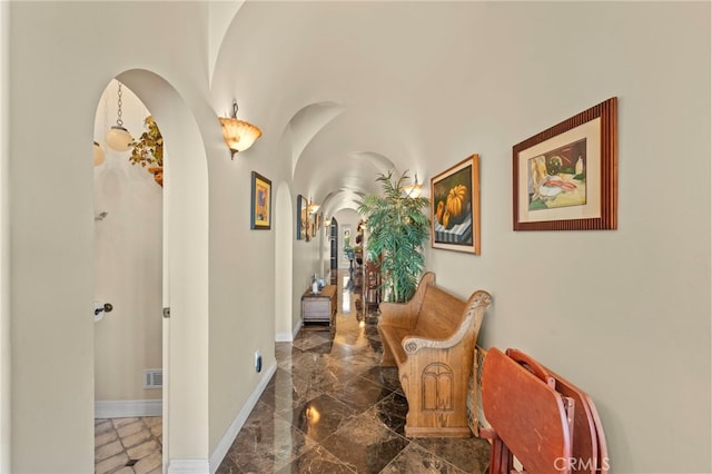 30594 Longhorn Dr, Canyon Lake, CA 92587 - hall with arched walkways, marble tiled floors, and baseboards
