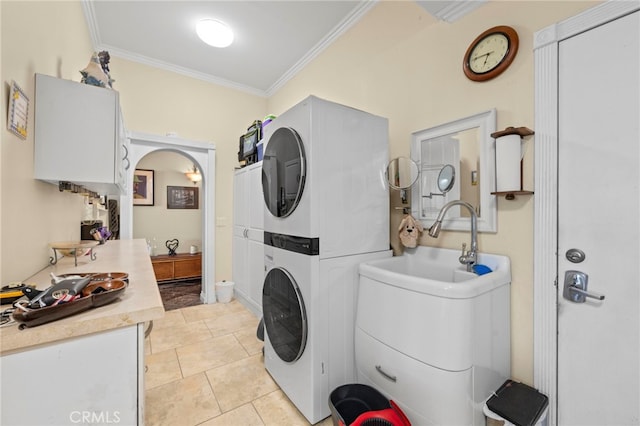 30594 Longhorn Dr, Canyon Lake, CA 92587 - laundry area with stacked washer and clothes dryer, crown molding, light tile patterned floors, and arched walkways