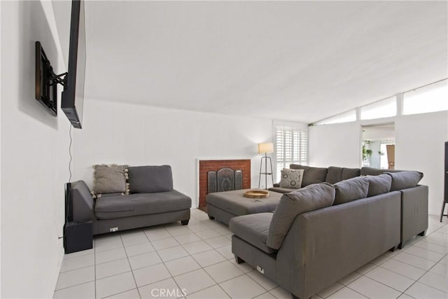 living area with light tile patterned floors and lofted ceiling
