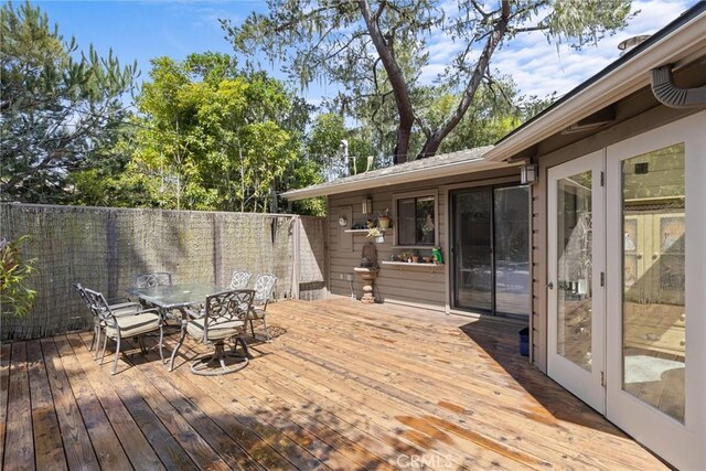 deck with fence and outdoor dining area