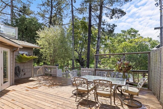 wooden terrace featuring outdoor dining area