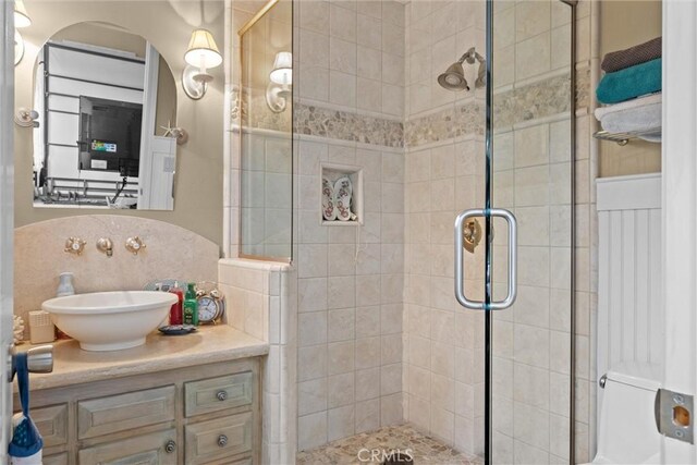 bathroom with a stall shower and vanity