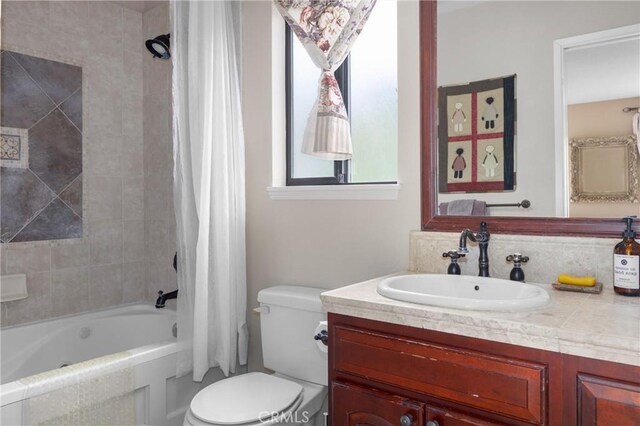 bathroom featuring shower / bath combination with curtain, a healthy amount of sunlight, toilet, and vanity