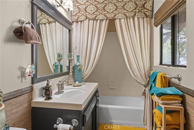 bathroom with washtub / shower combination and vanity