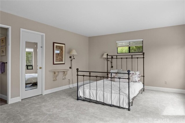 bedroom with carpet flooring and baseboards