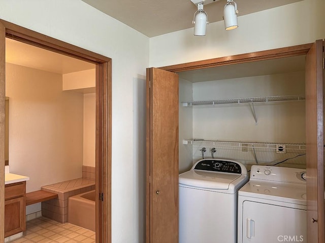 clothes washing area with laundry area and washer and clothes dryer