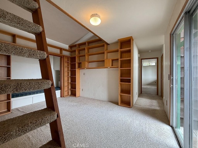 interior space with carpet flooring and lofted ceiling