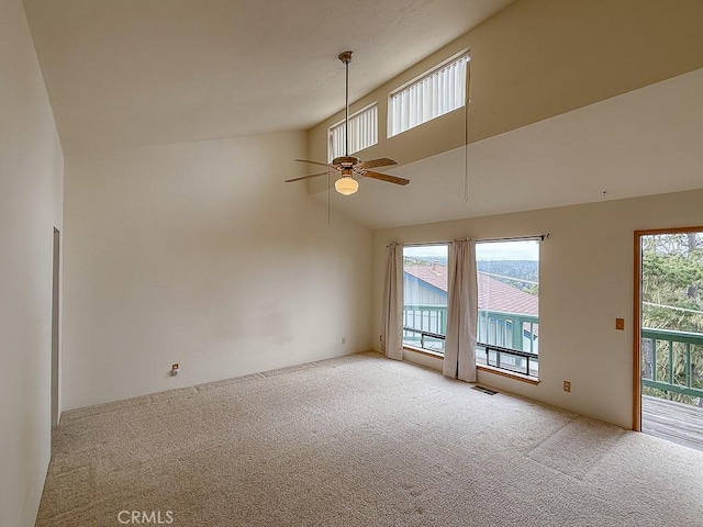 unfurnished room featuring light carpet, high vaulted ceiling, a ceiling fan, and visible vents