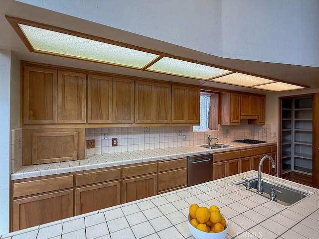 kitchen featuring dishwasher, a sink, and backsplash