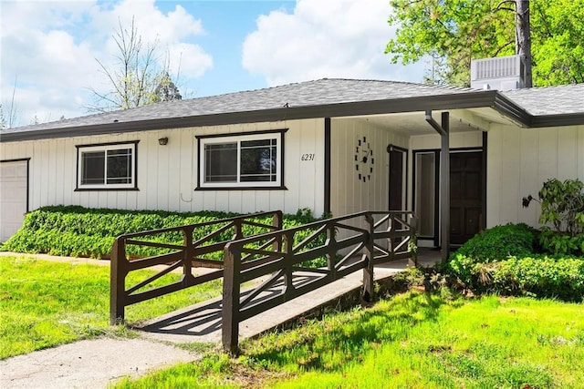 ranch-style house featuring a porch, roof with shingles, and cooling unit
