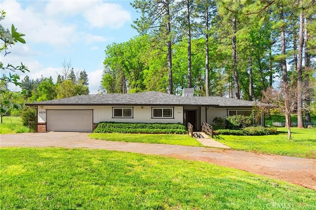 single story home featuring a garage, driveway, a chimney, and a front lawn